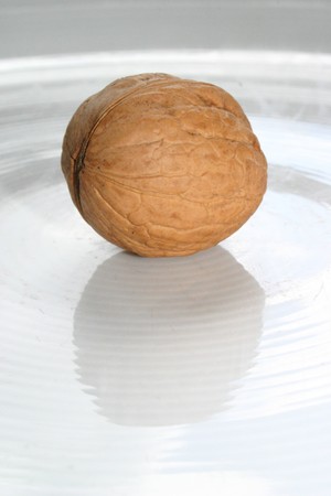 Walnut with nutshell on a white dishの写真素材