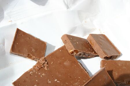 Bar of chocolate divided into pieces in wrapping