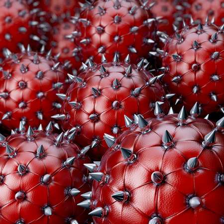 Red leather balls, chesterfield style, with reflecting steel spikes, 3d rendering with depth blurの写真素材