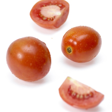 Tomato and slices of tomato on white backgroundの写真素材