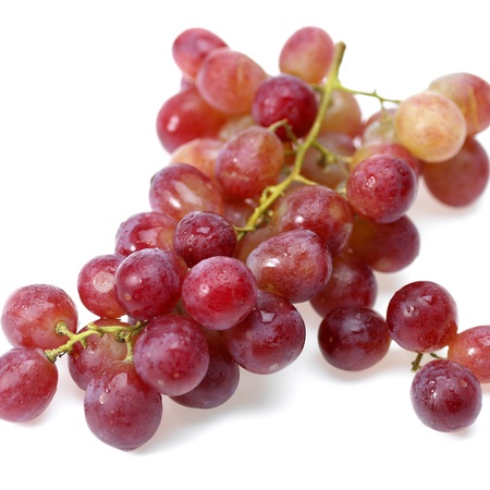 Grape cluster with leaves isolated on a white backgroundの写真素材