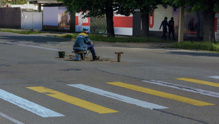 A road worker in the middle of the highway.の写真素材