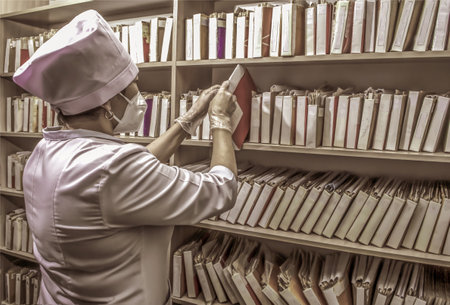 A medical worker among patient catalogs.の写真素材
