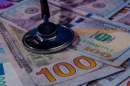A stethoscope on the background of a $100 bill. A symbol of the strength and exchange rate of the US dollar.の写真素材