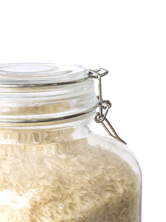 close up rice in the glass jar ,isolated on whiteの写真素材