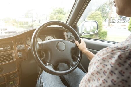 woman driving a car in the city with vintage shirt