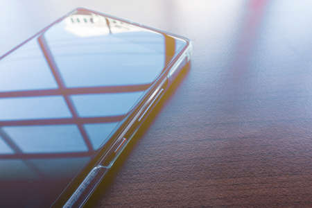 Technology and communication in small device on wood の写真素材