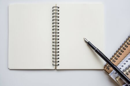 mock up top view notebooks and pen on background white tableの写真素材