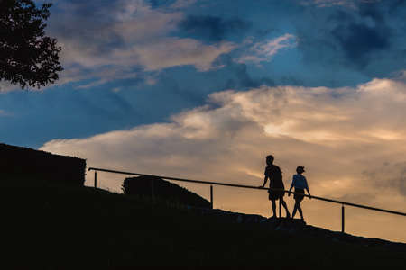 man and woman sweetheart in the garden. blue sky and twilight sparkleの写真素材