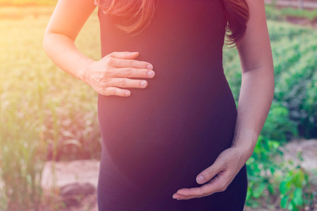 a pregnant woman travel in farm, Show Belly, baby coming soon on the worldの写真素材