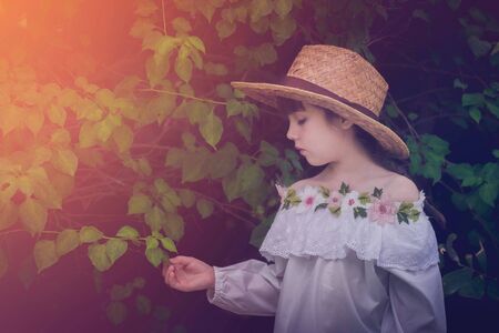 a little cute girl alone in the garden or farm and outside in natureの写真素材