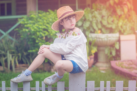 a little cute girl alone in the garden or farm and outside in natureの写真素材