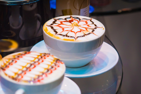 The Late arts coffee. Coffee arts.  Two hot coffee set in a white cup on desk or tableの写真素材