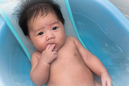 baby smiling and happy  shower in bathroom with mother