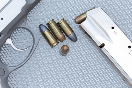 Close up 9 mm pistol ammunition is placed on the grill.