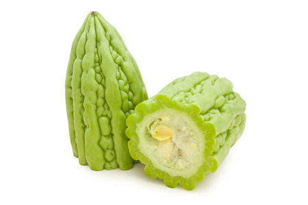 Halved cut bitter melons in isolated white backgroundの写真素材