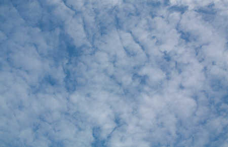 Blue sky panorama with fluffy white clouds.