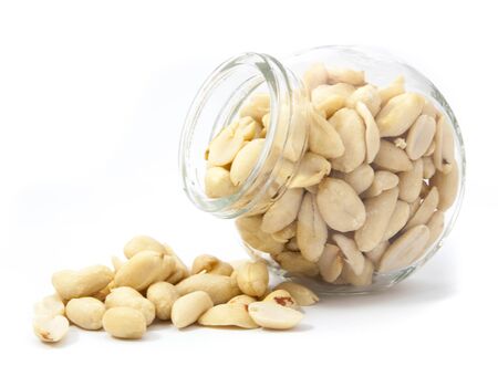 peanuts isolate on a white background from glass jar