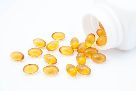 Omega 3 fish oil capsules and bottleの写真素材