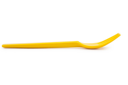 yellow plastic fork isolated on white background