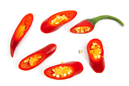 cut red hot chili peppers capsicum on a white backgroundの写真素材