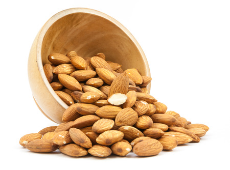 bowl wood of almonds isolated on white backgroundの写真素材