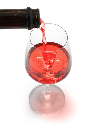 red wine pouring  isolated on white backgroundの写真素材