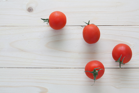 tomatoes on wood tableの写真素材