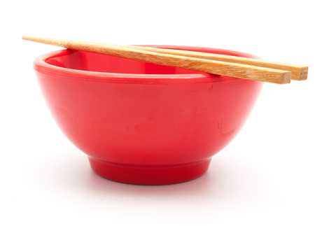 empty red bowl and chopstick isolated on white backgroundの写真素材