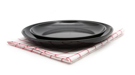 empty black plate with napkin on white backgroundの写真素材
