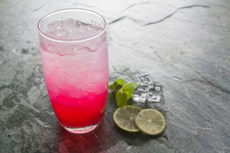 red soda lime drink with lime on stone.の写真素材