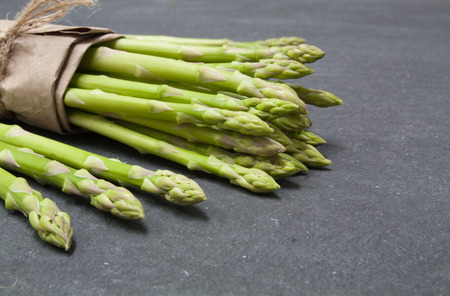 bunch of asparagus over slate backgroundの写真素材