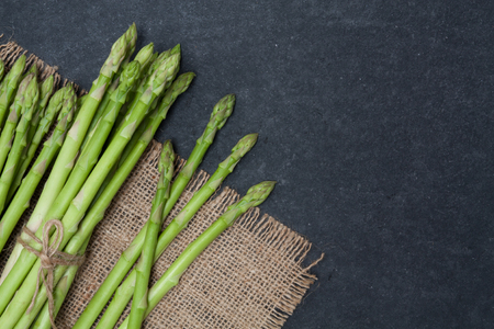 bunch of asparagus over slate backgroundの写真素材