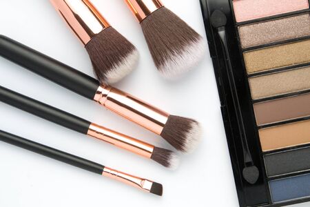 Makeup brush set with eye shadow palette on white  backgroundの写真素材