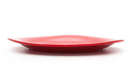 empty red plate on the white backgroundの写真素材