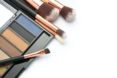 Makeup brush set with eye shadow palette on white  background