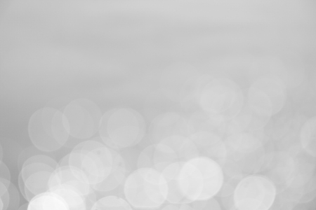 silver and white bokeh lights abstract backgroundの写真素材