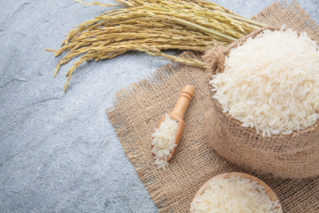 thai fragrant jasmine rice in a bowl with gold spike on Sackの写真素材