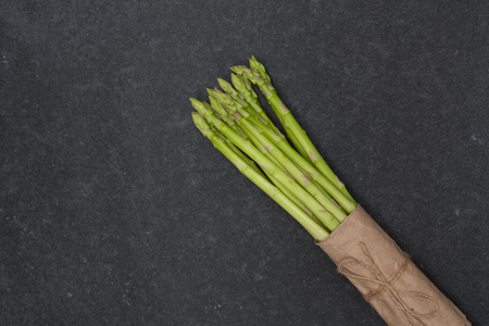 bunch of asparagus over slate backgroundの写真素材