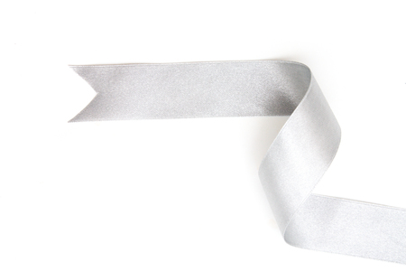 silver ribbon bow in bright silver white grey color isolated on white backgroundの写真素材