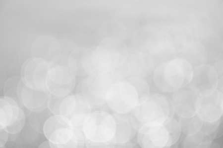 silver and white bokeh lights abstract backgroundの写真素材