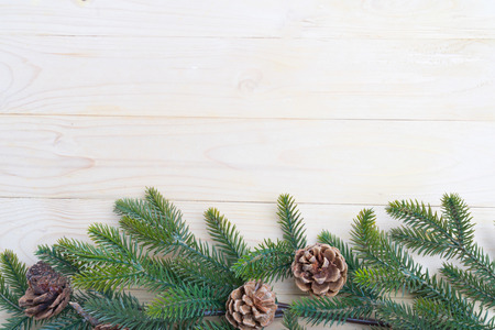 christmas background fir leaves and pine cones decorating on white wood table