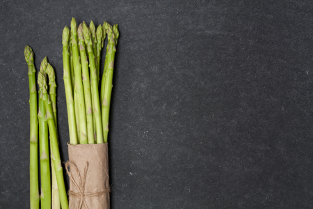 bunch of asparagus over slate backgroundの写真素材