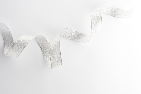 silver ribbon bow  on white isolated backgroundの写真素材