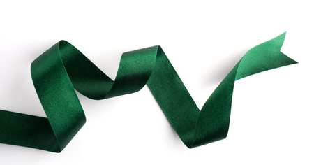 Green bow ribbon satin texture isolated on white backgroundの写真素材