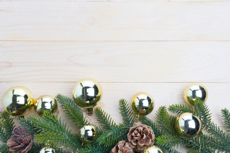 christmas background fir leaves and pine cones decorating on white wood tableの写真素材