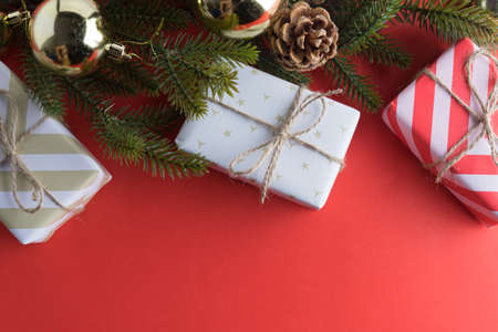 christmas gift presents in decorative boxes on red backgroundの写真素材