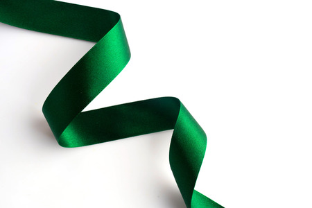 Green bow ribbon satin texture isolated on white backgroundの写真素材