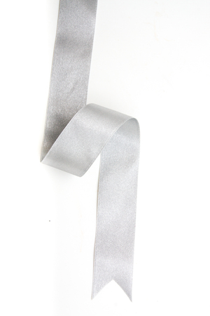 silver ribbon bow in bright silver white grey color isolated on white backgroundの写真素材