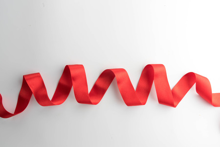 red bow ribbon satin texture isolated on white backgroundの写真素材